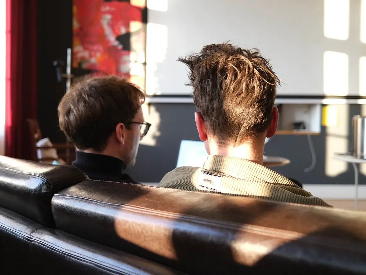 Die hej.build Gründer Michael Rahmfeld und Hannes Eberlein in einer konzentrierten Arbeitsbesprechung, Sinnbild für die intensive Zusammenarbeit und strategische Tiefe ihrer Unternehmensberatung.
