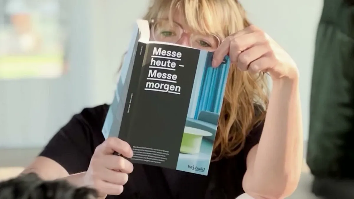 A woman reading our trade fair guide